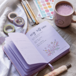 Pastel journal setup with linen fabric, washi tape, gel pens, and a matcha latte.