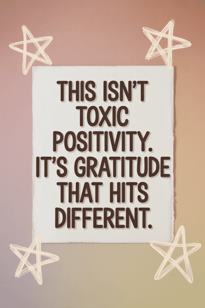 Minimal poster-style digital graphic with soft textured background and handwritten black ink text reading “This isn’t toxic positivity. It’s gratitude that hits different.” Includes hand-drawn white stars in each corner on a pink-to-beige gradient.