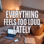 Emotionally overwhelmed girl sitting on messy bed surrounded by laptop, journal, laundry, phone, and dim warm lighting.